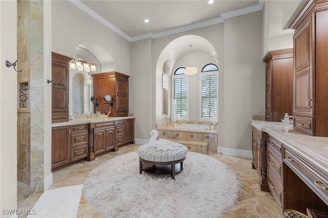 bathroom with a bathtub, ornamental molding, and vanity