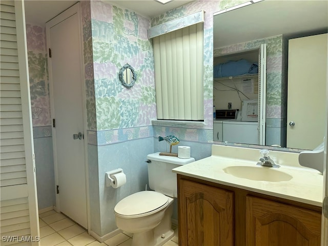 bathroom featuring tile patterned floors, toilet, independent washer and dryer, and vanity