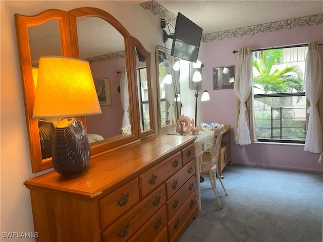 home office with a textured ceiling and carpet floors