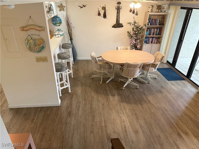 dining area with dark hardwood / wood-style flooring