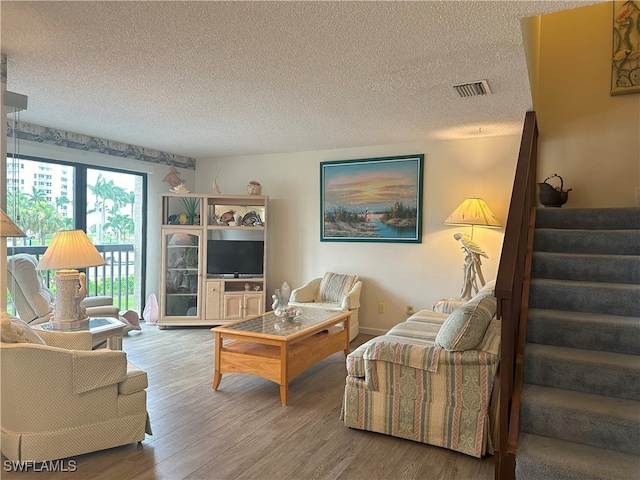 living room with hardwood / wood-style flooring and a textured ceiling