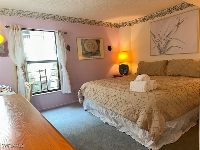 bedroom with a textured ceiling and carpet