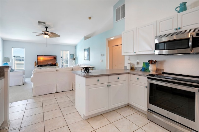 kitchen with stainless steel appliances, light tile patterned floors, white cabinets, ceiling fan, and kitchen peninsula