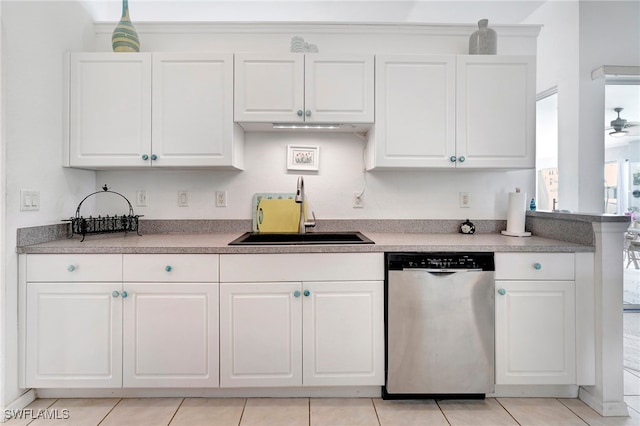 kitchen featuring light tile patterned flooring, sink, stainless steel dishwasher, and white cabinetry