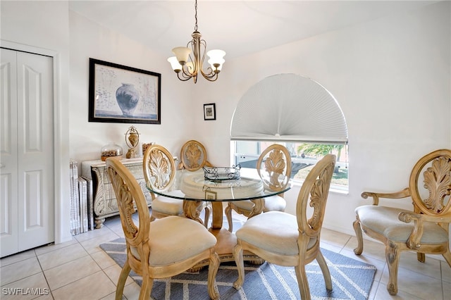 tiled dining room with an inviting chandelier