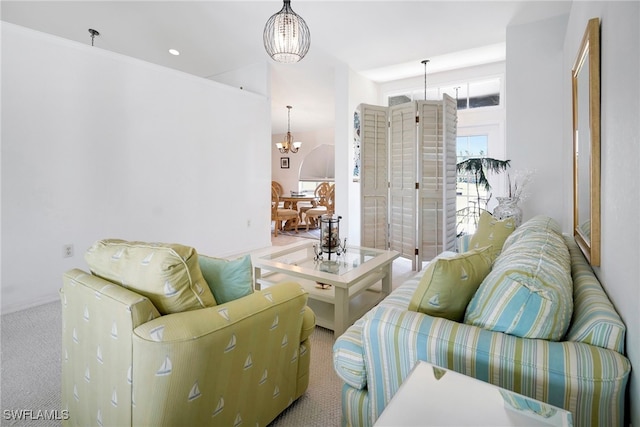 carpeted living room featuring a notable chandelier