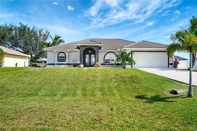 mediterranean / spanish-style home featuring a front yard and a garage