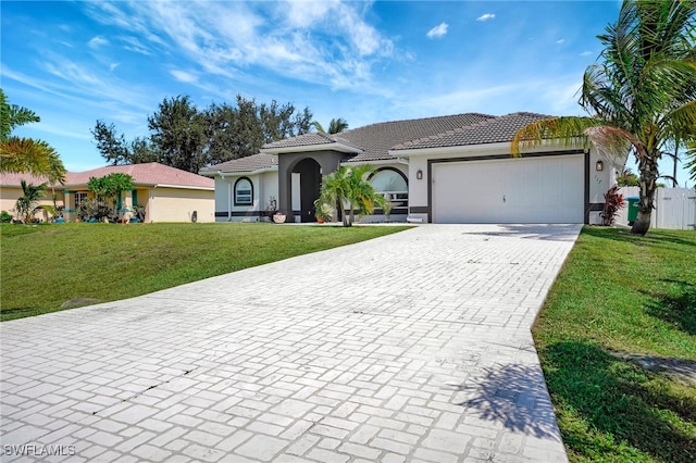 mediterranean / spanish home with a front lawn and a garage