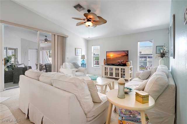 carpeted living room with vaulted ceiling and ceiling fan