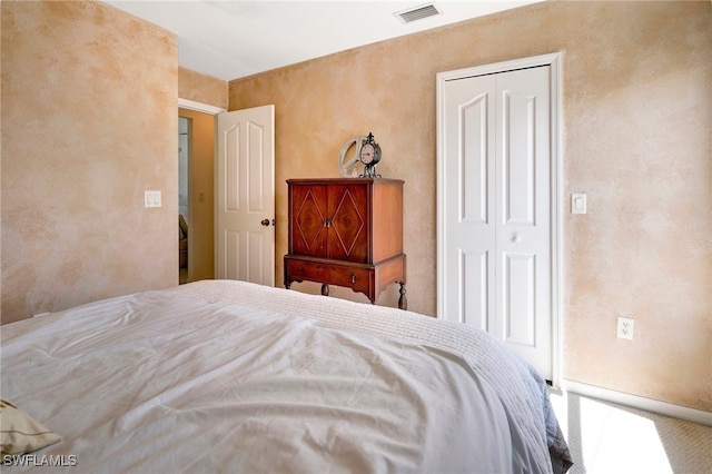 bedroom with carpet and a closet