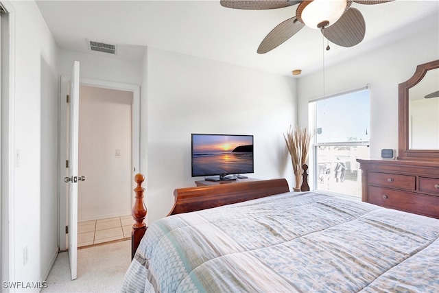 bedroom featuring ceiling fan and light carpet