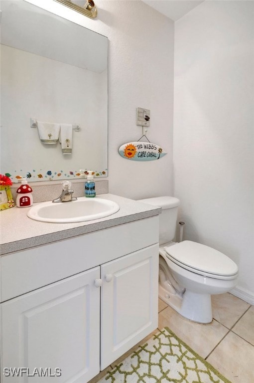 bathroom with tile patterned floors, vanity, and toilet