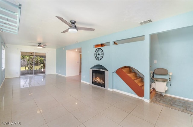 unfurnished living room with tile patterned floors and ceiling fan