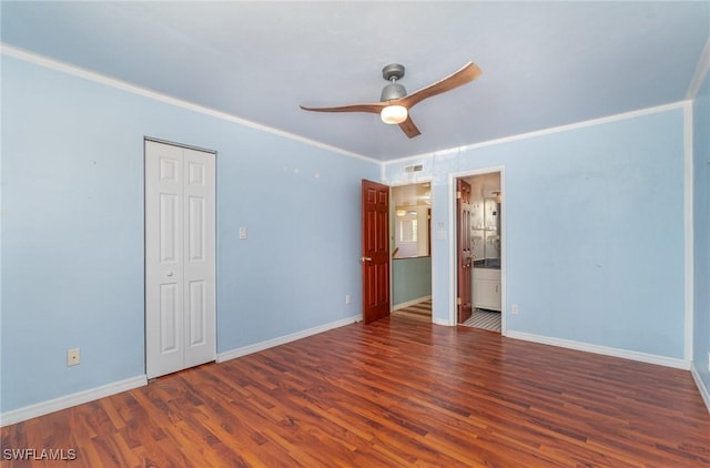 unfurnished bedroom featuring ornamental molding, ensuite bathroom, ceiling fan, and dark hardwood / wood-style flooring