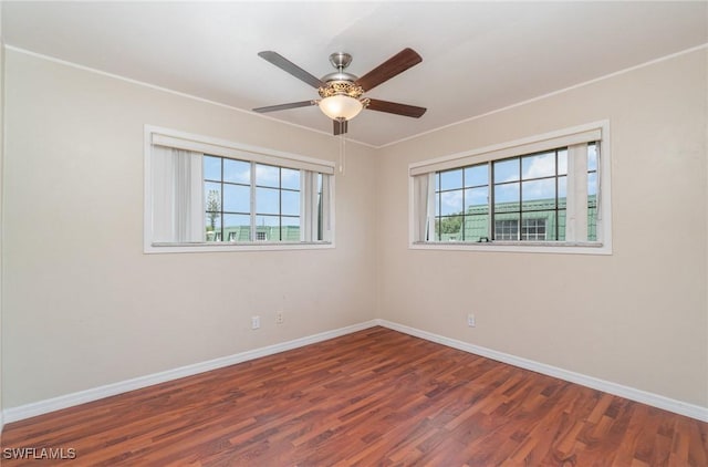 spare room with ceiling fan and dark hardwood / wood-style flooring