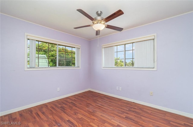 unfurnished room with crown molding, ceiling fan, and dark hardwood / wood-style floors