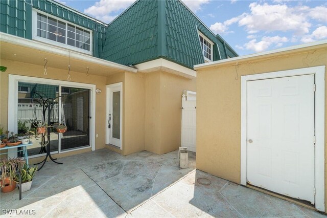 entrance to property featuring a patio area