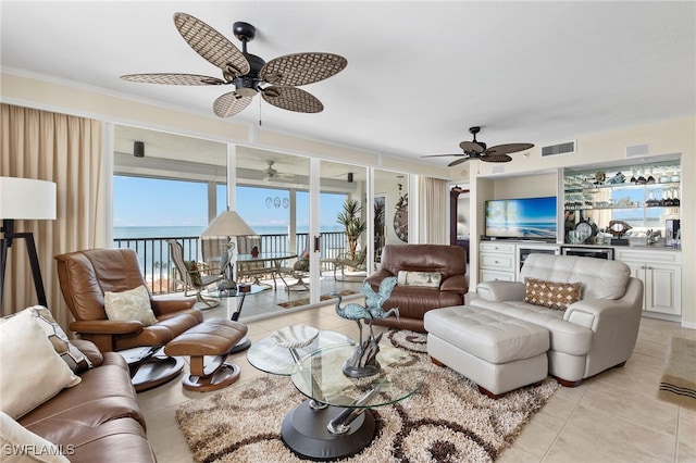 tiled living room featuring a water view and ornamental molding