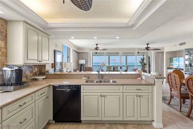 kitchen featuring kitchen peninsula, dishwasher, sink, a tray ceiling, and cream cabinets