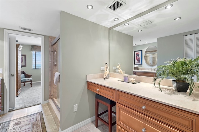 bathroom featuring tile patterned floors, vanity, and an enclosed shower