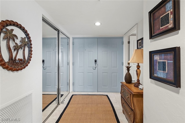 entryway with light tile patterned floors