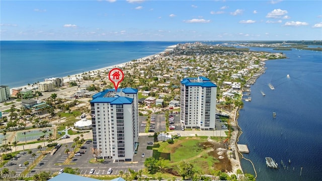 birds eye view of property with a beach view and a water view