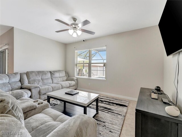 tiled living room with ceiling fan