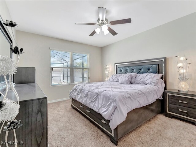 bedroom with ceiling fan and light colored carpet