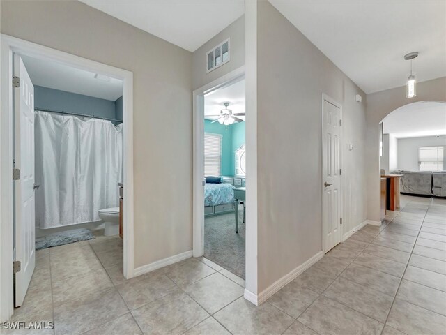 hallway with light tile patterned floors