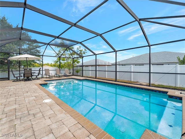 view of pool with a patio area and a lanai