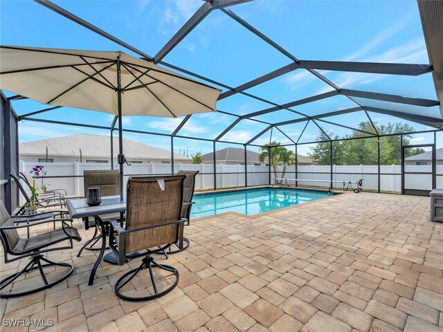 view of swimming pool with a lanai and a patio area