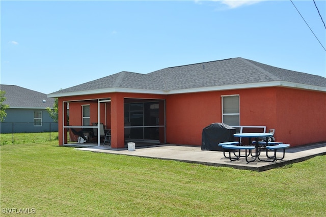 rear view of house with a yard and a patio area