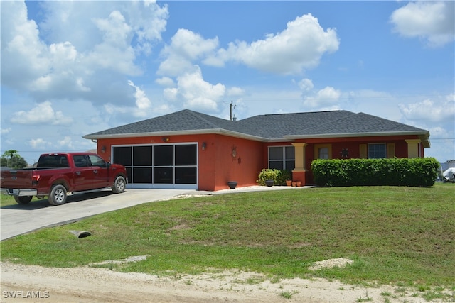 single story home with a front yard and a garage