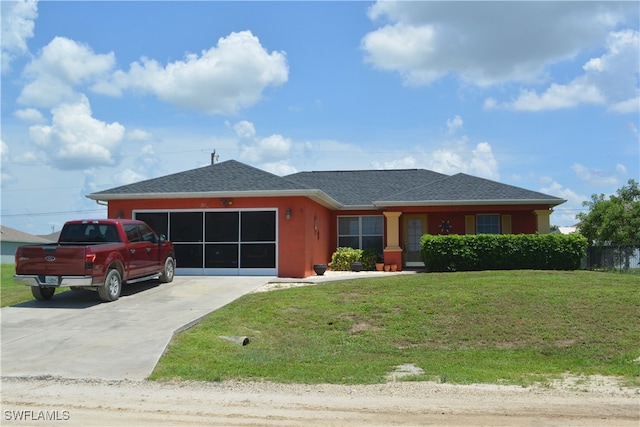 single story home featuring a garage and a front yard