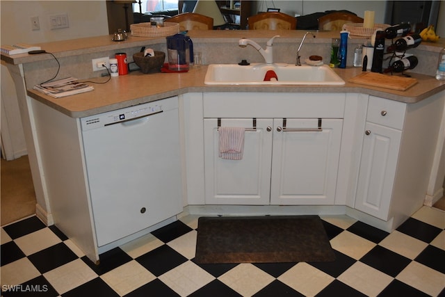 kitchen with dishwasher, sink, light tile patterned flooring, and white cabinetry