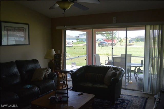 living room with ceiling fan, a wealth of natural light, and vaulted ceiling