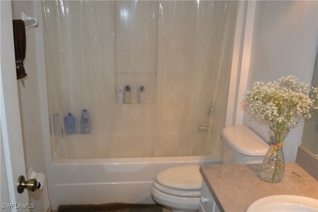 full bathroom with shower / tub combo, vanity, and toilet