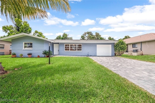 ranch-style house with a garage, central AC unit, and a front lawn