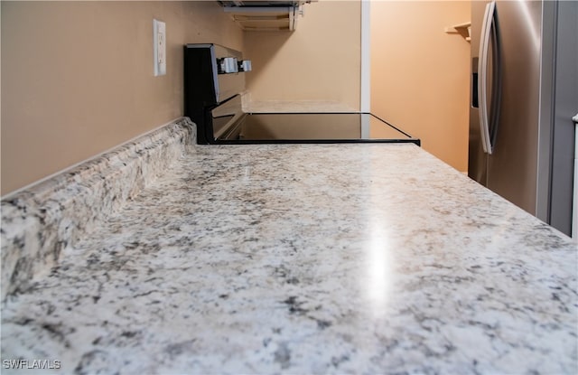 kitchen featuring range and stainless steel fridge with ice dispenser