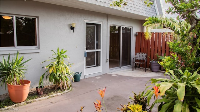 property entrance featuring a patio area