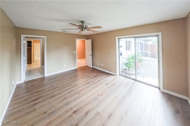 unfurnished room with a textured ceiling, hardwood / wood-style floors, and ceiling fan