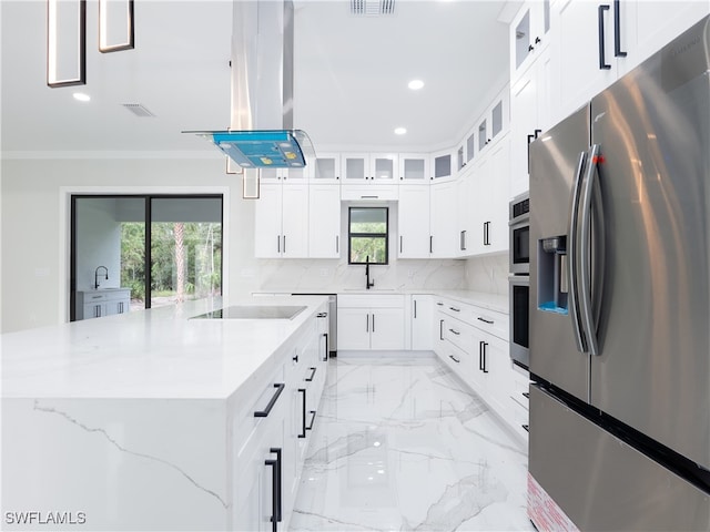 kitchen with stainless steel fridge, white cabinets, backsplash, a kitchen island, and island exhaust hood