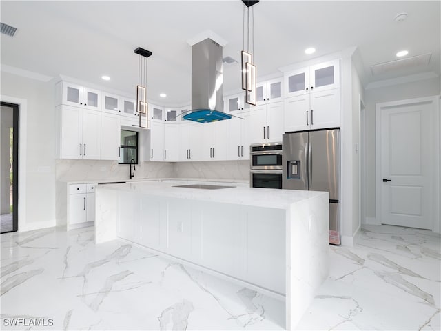 kitchen featuring white cabinetry, a kitchen island, stainless steel appliances, and tasteful backsplash