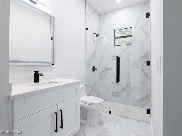 bathroom with vanity, toilet, and a shower with door