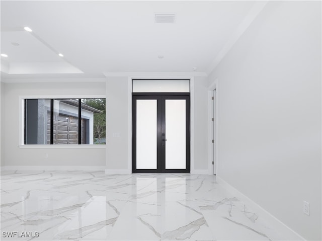 empty room featuring ornamental molding and french doors