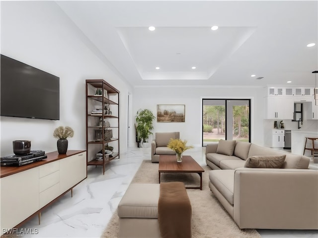 living room with a tray ceiling