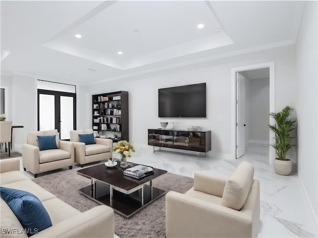 living room featuring a raised ceiling, crown molding, and french doors