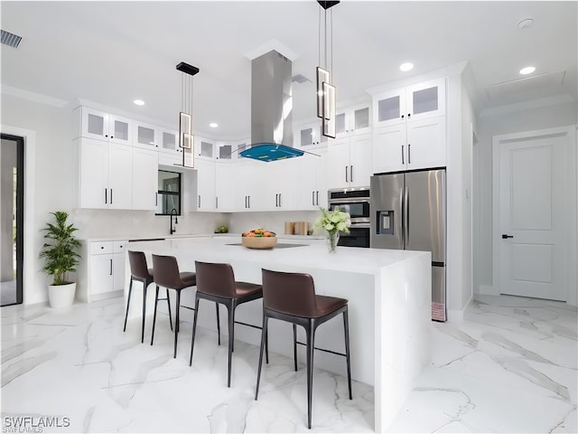 kitchen featuring decorative light fixtures, appliances with stainless steel finishes, decorative backsplash, and a kitchen island