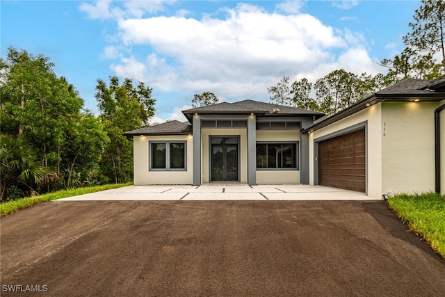 prairie-style house featuring a garage