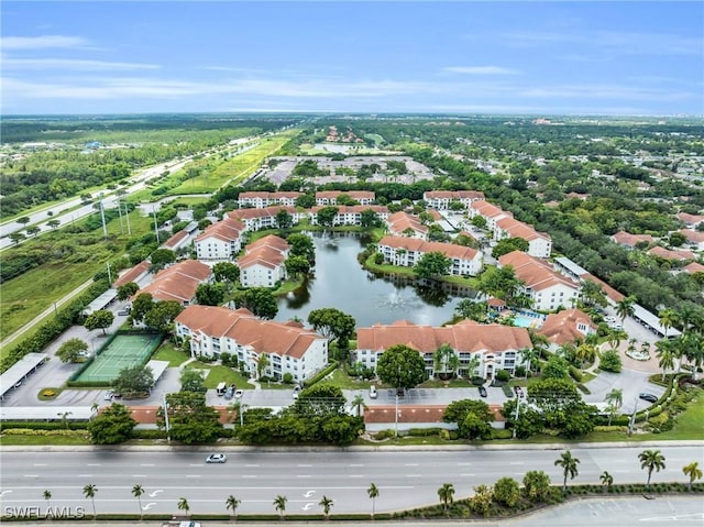 birds eye view of property with a water view and a residential view